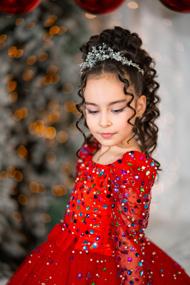 Young girl in a red dress with colorful sequins against a blurred festive background