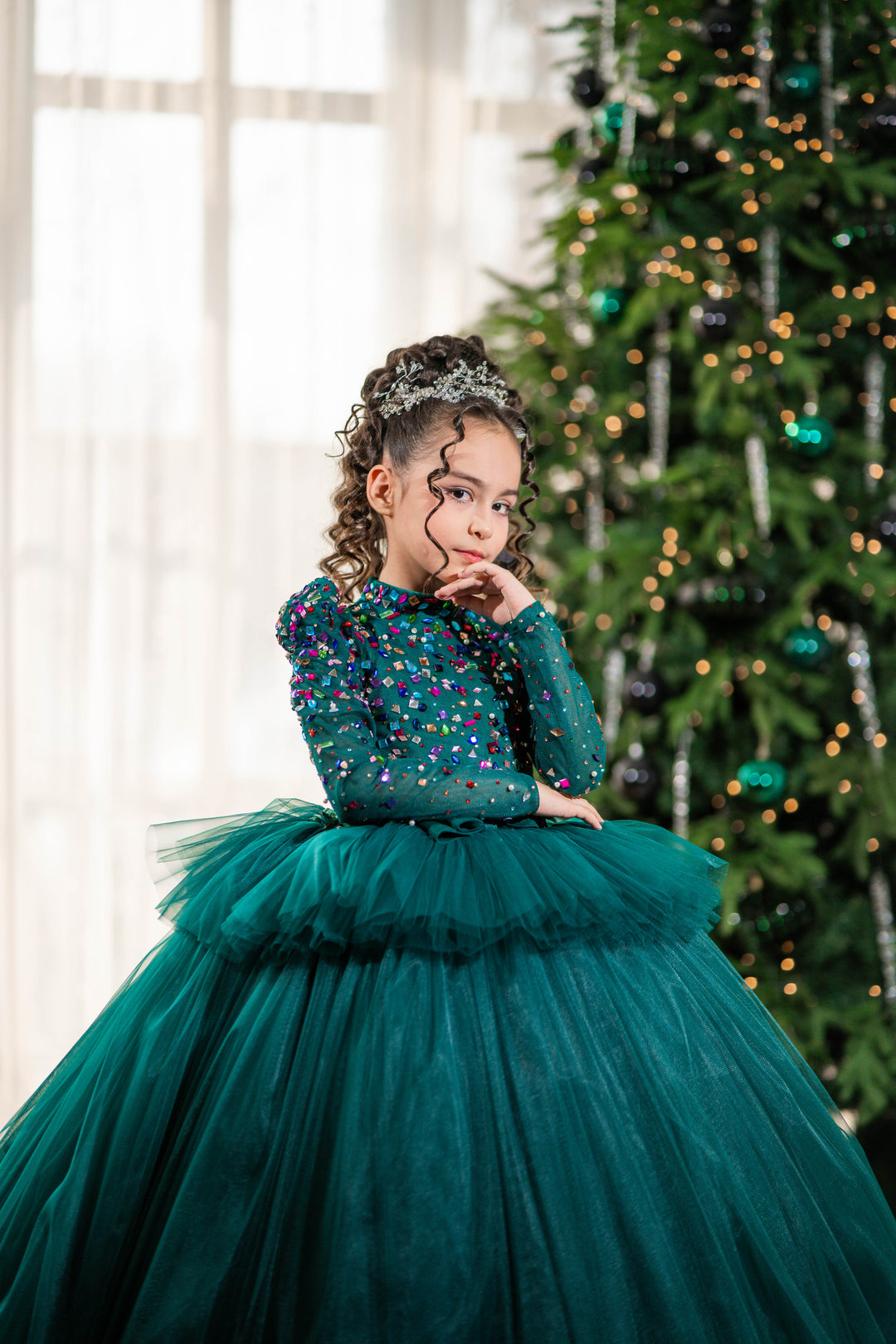 A girl in a green dress with a festive background